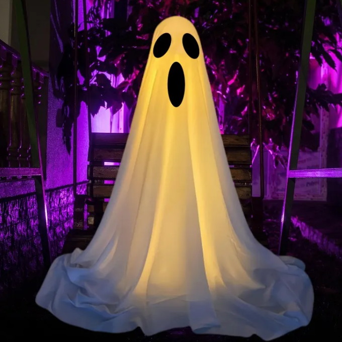 Ghost costume with glowing yellow light in a dark setting with purple lighting